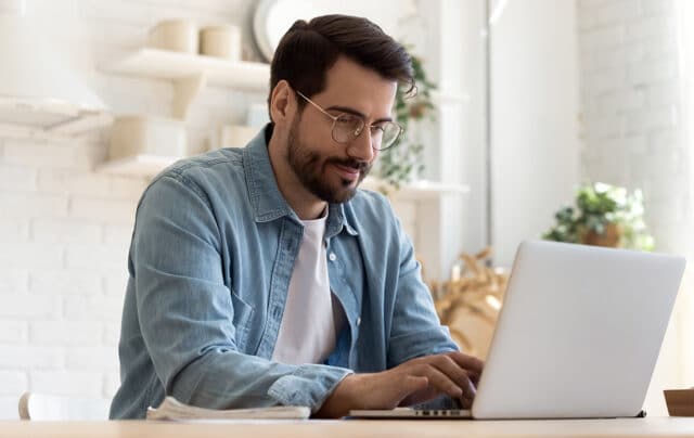 Man using a laptop, checking his personal data.