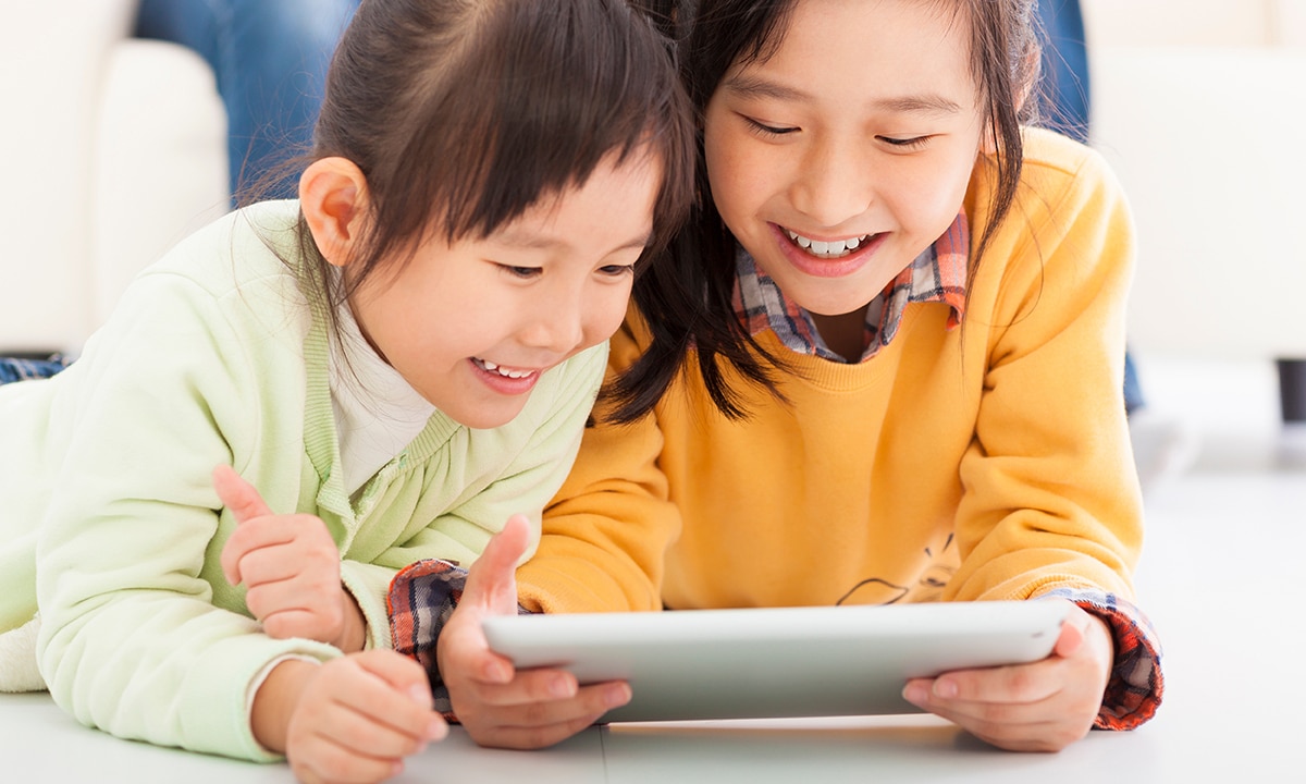 Two girls playing on a tablet